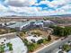 Drone shot of neighborhood with local businesses and nearby landscape at 5906 Bunch St, Las Vegas, NV 89122
