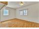Bright bedroom with laminate floors, ceiling fan and two windows for natural light at 5906 Bunch St, Las Vegas, NV 89122