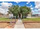Charming home featuring mature trees, a chain-link fence, and a paved walkway to the front door at 5906 Bunch St, Las Vegas, NV 89122