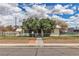 Charming single-story home with mature trees, and a chain link fence enclosing the front yard at 5906 Bunch St, Las Vegas, NV 89122