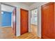 Hallway with views of bedrooms and wood-look laminate flooring at 5906 Bunch St, Las Vegas, NV 89122