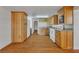 Warm-toned kitchen featuring wood cabinets, granite counters, and modern appliances at 5906 Bunch St, Las Vegas, NV 89122