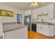 Bright kitchen with granite countertops, stainless steel fridge, and white cabinets at 5906 Bunch St, Las Vegas, NV 89122
