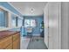 Blue laundry room with sink, water heater, storage, and a window for natural light at 5906 Bunch St, Las Vegas, NV 89122