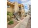 Beige two-story exterior featuring a stairway to the 2nd level with black metal railings and desert landscaping at 601 Cabrillo Cir # 754, Henderson, NV 89015