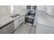 Updated kitchen featuring stainless steel appliances, quartz counters, white cabinets, and light hardwood floors at 601 Cabrillo Cir # 754, Henderson, NV 89015