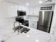 Bright kitchen featuring stainless steel appliances, marble countertops, white cabinetry, and stainless steel sink at 601 Cabrillo Cir # 754, Henderson, NV 89015