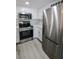 Updated kitchen featuring stainless steel appliances, white cabinets, and light hardwood floors at 601 Cabrillo Cir # 754, Henderson, NV 89015