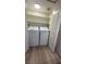 Bright laundry room features a white washer and dryer, complemented by neutral walls and shelving for organized storage at 601 Cabrillo Cir # 754, Henderson, NV 89015