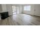 Bright living room features a fireplace, wood look flooring, and sliding glass doors to a balcony at 601 Cabrillo Cir # 754, Henderson, NV 89015