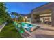 This backyard features a shimmering pool, outdoor lounge chairs, and a covered patio perfect for relaxing and entertaining at 6103 Stone Rise St, Las Vegas, NV 89135