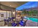Resort-style backyard with an outdoor kitchen, inviting pool, and dining area perfect for entertaining at 6103 Stone Rise St, Las Vegas, NV 89135