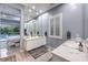 Modern bathroom featuring double sinks, a large mirror, and natural light, adjacent to the main bedroom and pool view at 6103 Stone Rise St, Las Vegas, NV 89135