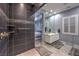 Modern bathroom with large vanity, tiled shower, and access to the Primary bedroom at 6103 Stone Rise St, Las Vegas, NV 89135