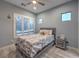Comfortable bedroom with plantation shutters, ceiling fan, and modern decor at 6103 Stone Rise St, Las Vegas, NV 89135