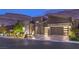 Beautiful modern home featuring a stylish facade, manicured landscaping, and an attached two-car garage at 6103 Stone Rise St, Las Vegas, NV 89135