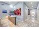 Modern hallway with a bar area featuring custom shelving and stylish artwork at 6103 Stone Rise St, Las Vegas, NV 89135