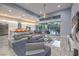 Spacious living room with a modern kitchen, comfortable seating, and access to the backyard at 6103 Stone Rise St, Las Vegas, NV 89135