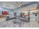 Expansive living room featuring modern furnishings, sleek tile floors, and an open layout to the kitchen and dining areas at 6103 Stone Rise St, Las Vegas, NV 89135