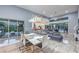 Open-concept living and dining area with modern decor, high ceilings, and access to the outdoors at 6103 Stone Rise St, Las Vegas, NV 89135