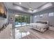 Serene main bedroom with a sliding glass door to the pool area and a tray ceiling with modern fan at 6103 Stone Rise St, Las Vegas, NV 89135