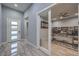 Stylish home office with a glass door, sleek desk, and custom shelving at 6103 Stone Rise St, Las Vegas, NV 89135