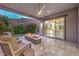 Relaxing covered patio featuring tile floors, modern ceiling fan and a fire pit for cool desert nights at 6103 Stone Rise St, Las Vegas, NV 89135