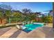 Enjoy the ambiance of this backyard, showcasing a sparkling pool, spa, and fire features for ultimate relaxation at 6103 Stone Rise St, Las Vegas, NV 89135