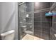 Modern tiled shower featuring glass doors, built-in shelves, and contemporary fixtures at 6103 Stone Rise St, Las Vegas, NV 89135