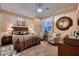 Comfortable bedroom featuring neutral decor and a cozy sitting area at 6373 Bridal Cave Ave, Las Vegas, NV 89131