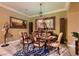 Formal dining room featuring a dining table with six chairs, elegant lighting and decorative accents at 6373 Bridal Cave Ave, Las Vegas, NV 89131