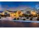 Charming home featuring a brick driveway, manicured landscaping, and elegant exterior lighting at 6373 Bridal Cave Ave, Las Vegas, NV 89131