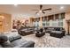 Spacious living room featuring comfortable leather seating and large windows at 6373 Bridal Cave Ave, Las Vegas, NV 89131