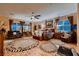 Spacious main bedroom with multiple windows, ceiling fan and sitting area at 6373 Bridal Cave Ave, Las Vegas, NV 89131