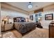 Comfortable bedroom featuring stylish decor, decorative lamps, a plush bed and neutral-toned striped walls at 6373 Bridal Cave Ave, Las Vegas, NV 89131