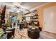Cozy office space featuring functional shelving, a work desk, and plants at 6373 Bridal Cave Ave, Las Vegas, NV 89131