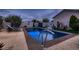 Backyard pool with stone trim, sun decorations, and a waterfall feature at 6373 Bridal Cave Ave, Las Vegas, NV 89131