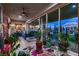 A sun room filled with plants, stylish furniture, and sliding glass doors leading to the backyard at 6373 Bridal Cave Ave, Las Vegas, NV 89131