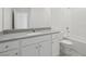 Bathroom features a modern vanity with granite countertop and bathtub at 6755 Violet Cascade Ave, Las Vegas, NV 89156