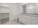 Bright bathroom with dual sink vanity, granite countertop, and a walk-in closet at 6755 Violet Cascade Ave, Las Vegas, NV 89156