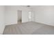 Spacious bedroom featuring neutral carpet and a view into the bathroom at 6755 Violet Cascade Ave, Las Vegas, NV 89156