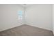 Cozy bedroom with plush carpeting and a large window at 6755 Violet Cascade Ave, Las Vegas, NV 89156