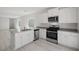 Modern kitchen featuring stainless steel appliances, white cabinetry and a stylish countertop at 6755 Violet Cascade Ave, Las Vegas, NV 89156