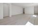 Spacious open-concept living space featuring modern flooring and neutral walls at 6755 Violet Cascade Ave, Las Vegas, NV 89156