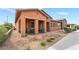 Attractive home with stone accents, a covered porch, and drought-resistant landscaping, offering curb appeal at 715 Orange Plume Walk, Henderson, NV 89011