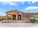 Charming single-story home with a covered porch and a stone-accented facade at 715 Orange Plume Walk, Henderson, NV 89011