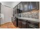 The kitchen features a stainless steel refrigerator and sleek cabinetry at 715 Orange Plume Walk, Henderson, NV 89011