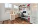 Well-lit office space with a long desk, white drawers, and floating shelves at 715 Orange Plume Walk, Henderson, NV 89011