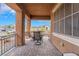 Cozy covered patio with outdoor seating, perfect for enjoying the neighborhood views and fresh air at 715 Orange Plume Walk, Henderson, NV 89011