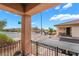 Charming porch with wrought iron railings and a view of the quiet street and neighborhood at 715 Orange Plume Walk, Henderson, NV 89011
